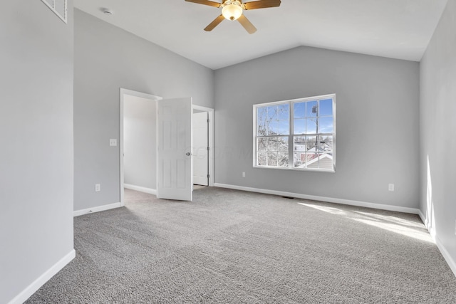 unfurnished bedroom with ceiling fan, carpet flooring, and vaulted ceiling