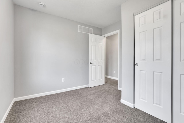 unfurnished bedroom with a closet and carpet