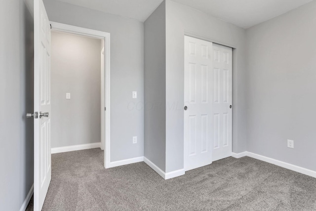 unfurnished bedroom with a closet and carpet