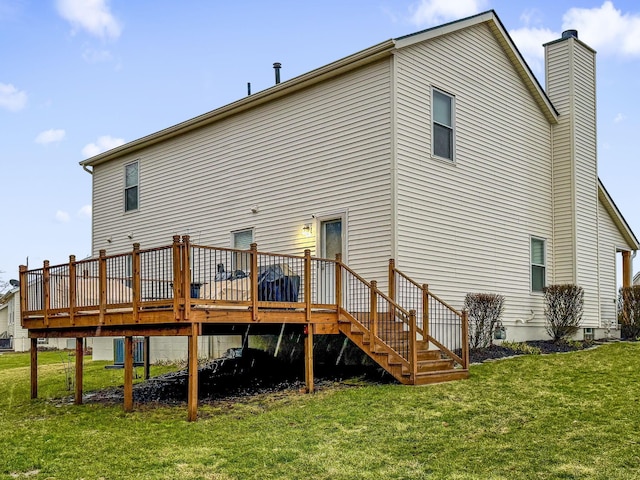 back of house with a lawn and a deck