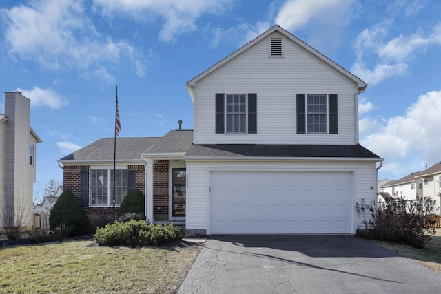 traditional home featuring driveway, roof with shingles, a front lawn, a garage, and brick siding