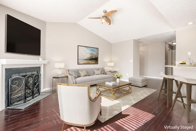 living room featuring dark wood-style floors, a fireplace, baseboards, and vaulted ceiling