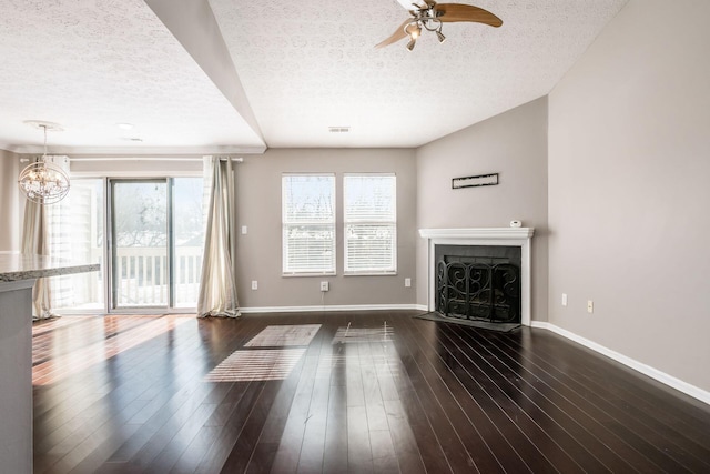 unfurnished living room featuring a fireplace with flush hearth, baseboards, and dark wood finished floors