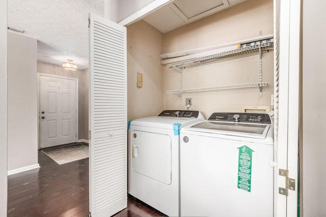 clothes washing area featuring laundry area, baseboards, dark wood finished floors, a textured ceiling, and washer and dryer