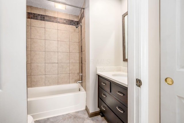 bathroom with tile patterned floors, bathtub / shower combination, a textured ceiling, and vanity