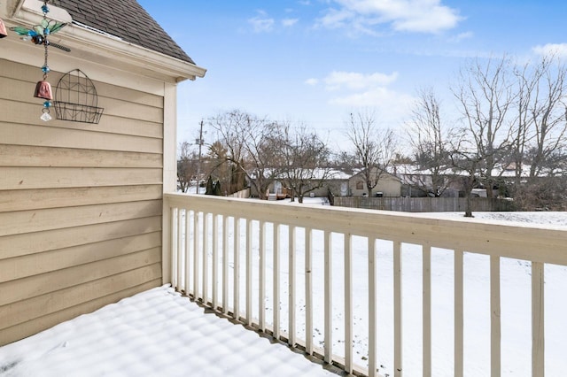 view of snow covered back of property