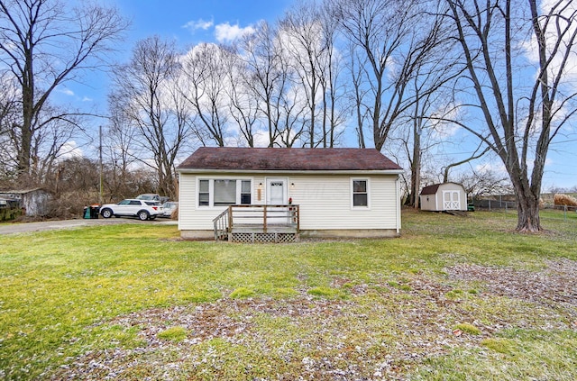 view of front of home with a shed and a front yard