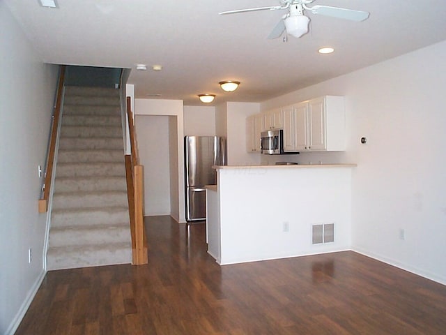 kitchen featuring light countertops, visible vents, appliances with stainless steel finishes, white cabinets, and a peninsula