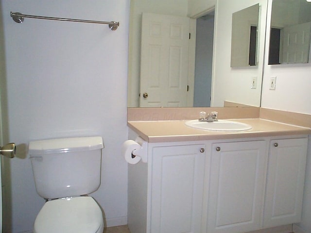 half bathroom featuring toilet and vanity