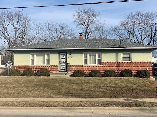 ranch-style home with a front lawn