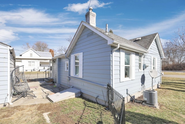 4461 Lancaster Ave, Columbus, OH 43207 - view of side of property with cooling unit, a yard, and a patio area