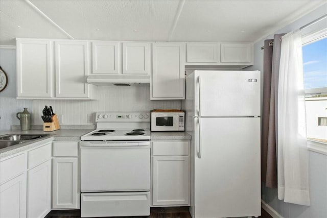 kitchen featuring white cabinetry, sink, and white appliances