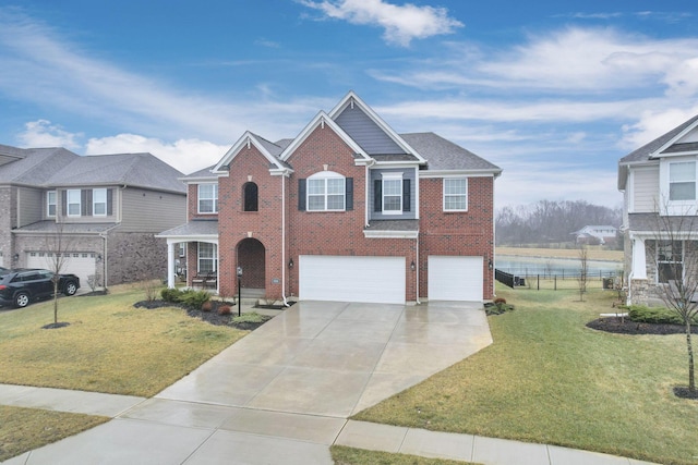 view of front of house featuring a water view, a garage, and a front lawn