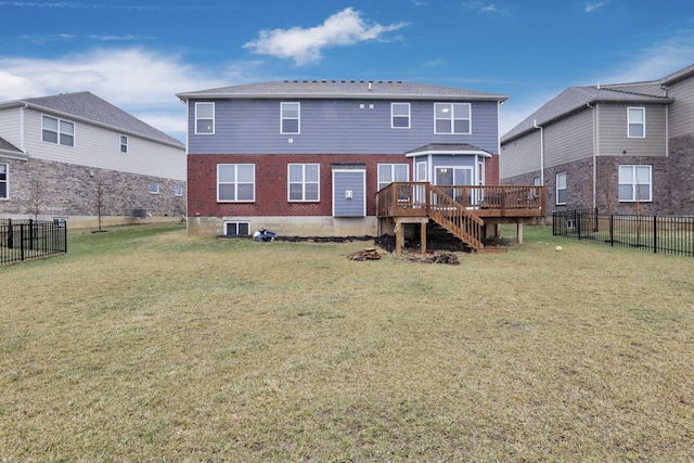 rear view of house featuring a yard and a deck