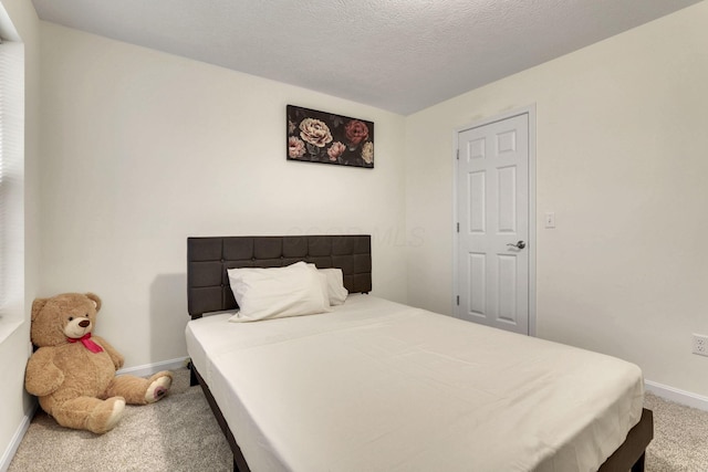 carpeted bedroom with a textured ceiling