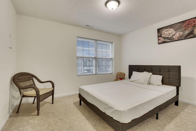 carpeted bedroom featuring a textured ceiling