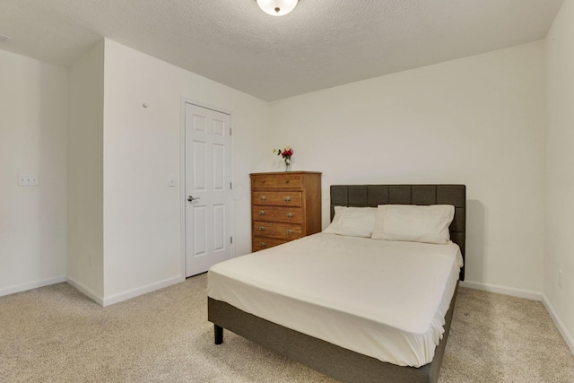 carpeted bedroom featuring a textured ceiling