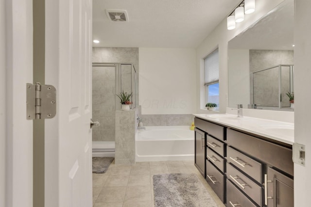 bathroom with tile patterned flooring, shower with separate bathtub, and vanity