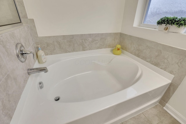 bathroom featuring tile patterned flooring and a bath