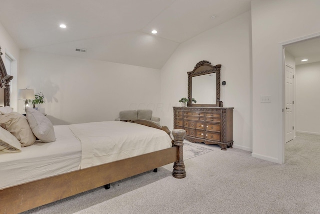 bedroom featuring light carpet and vaulted ceiling