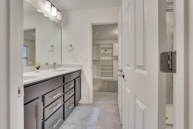 bathroom with vanity, a shower, and tile patterned floors