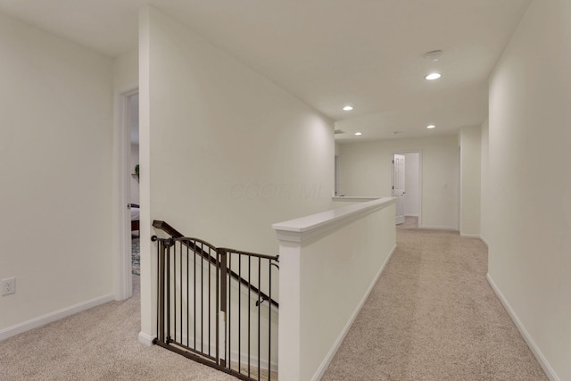 corridor with light colored carpet