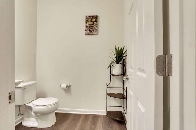 bathroom with hardwood / wood-style flooring and toilet