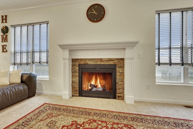 room details with a fireplace, ornamental molding, and carpet flooring