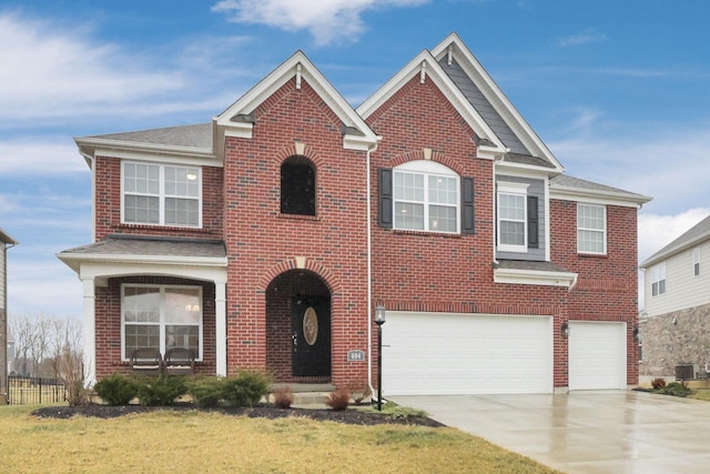 view of front of home featuring a garage, a front lawn, and central air condition unit