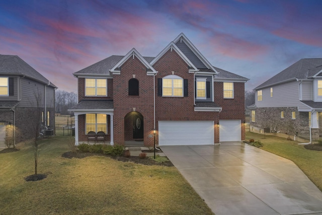 view of front facade featuring a garage and a yard