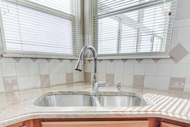 details featuring sink and tasteful backsplash