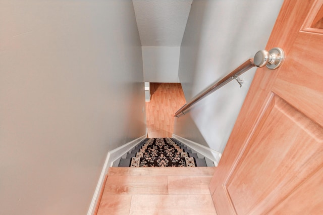 stairway with a textured ceiling