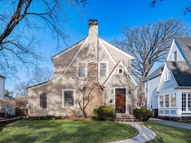 view of front facade with central AC unit, a chimney, and a front yard