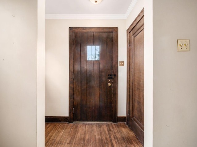 doorway to outside with ornamental molding, baseboards, and wood finished floors