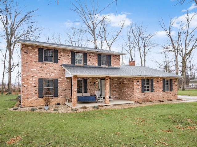 view of front of home with a patio area and a front yard