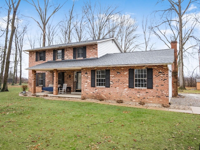 view of front of property with a front yard and a patio