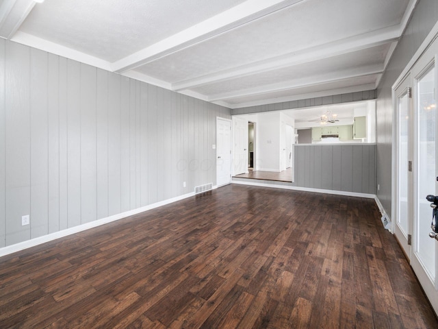 unfurnished living room with dark hardwood / wood-style floors and beamed ceiling