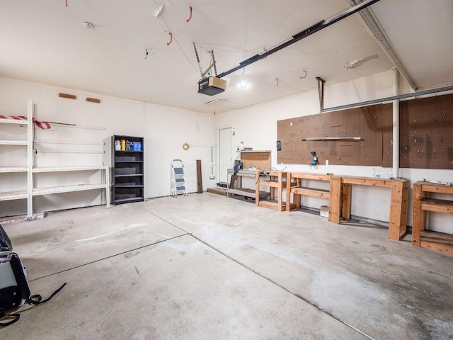 garage with a garage door opener and a workshop area