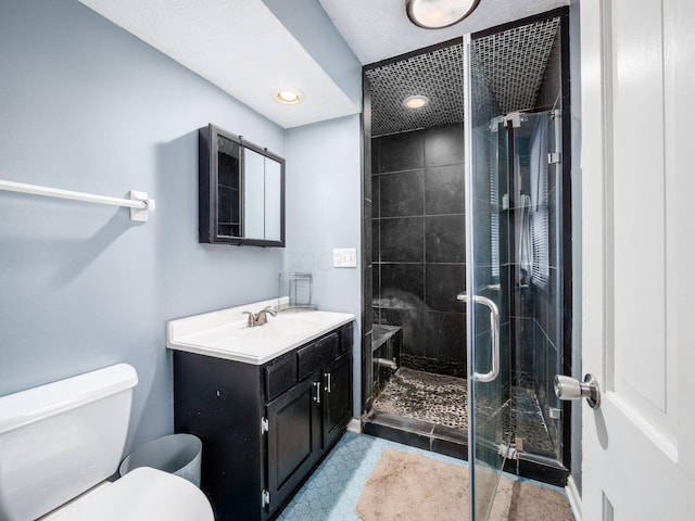 bathroom with vanity, toilet, and walk in shower