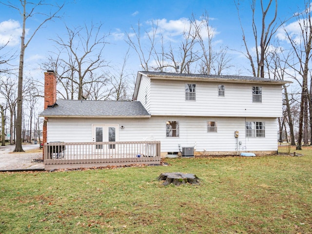 back of property featuring a wooden deck, a lawn, and cooling unit