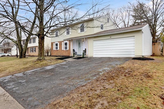 view of front of property with a garage and a front yard