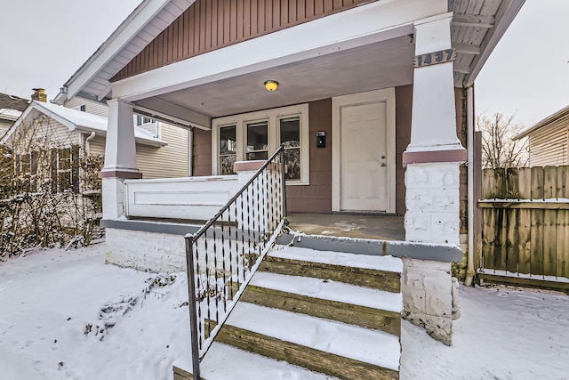 1437 Manchester Ave, Columbus, OH 43211 - snow covered property entrance with covered porch and fence
