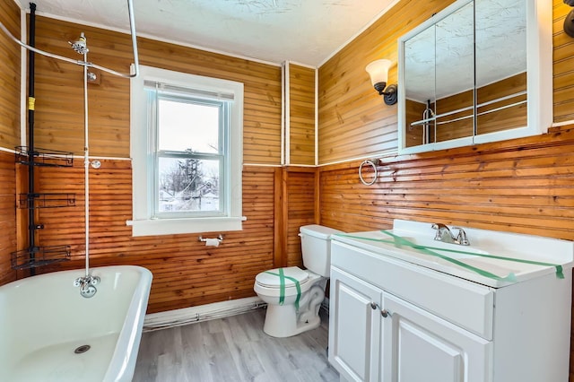 1437 Manchester Ave, Columbus, OH 43211 - bathroom featuring a freestanding tub, toilet, vanity, wood finished floors, and wood walls