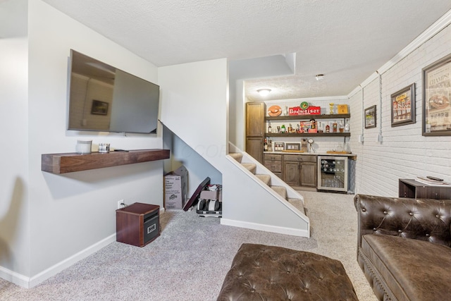 living room featuring wine cooler, brick wall, a textured ceiling, bar area, and light carpet