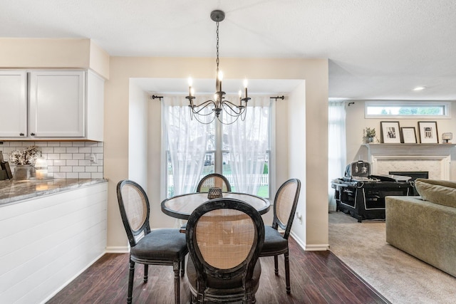 dining area featuring an inviting chandelier, dark hardwood / wood-style floors, and a wealth of natural light