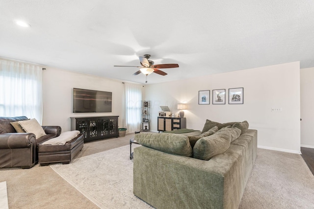 living room featuring ceiling fan and light carpet