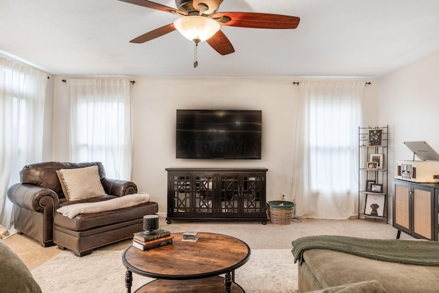 carpeted living room featuring plenty of natural light and ceiling fan