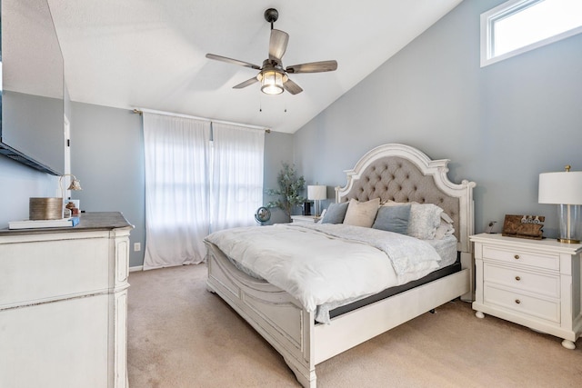 bedroom with ceiling fan, vaulted ceiling, and light carpet