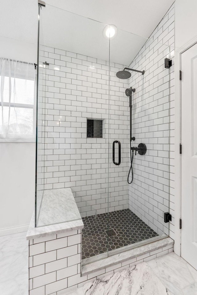 bathroom featuring a shower with door