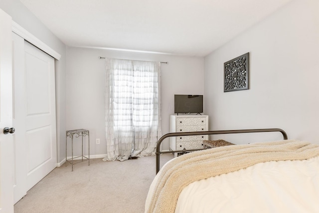 carpeted bedroom with a closet